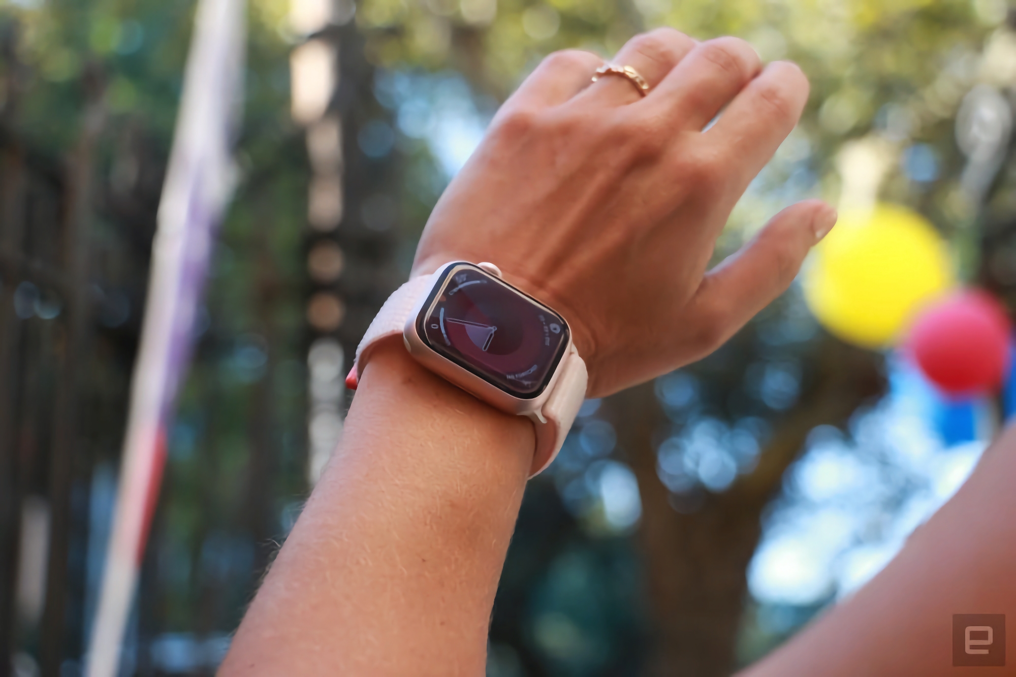 Image of a person wearing Apple Watch Series 9 on their left wrist.  The shot is shot from hand to forearm as the person raises their wrist up to see the watch face.