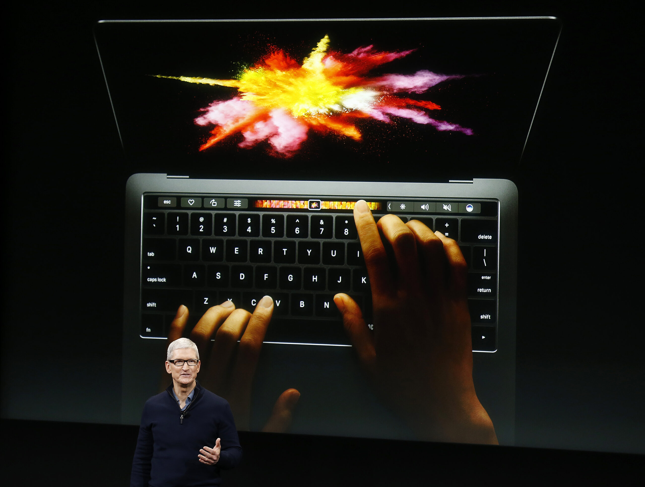 Apple CEO Tim Cook speaks under a graphic of the new MacBook Pro during an Apple media event in Cupertino, California, US on October 27, 2016. REUTERS/Beck Diefenbach TPX Photos of the Day